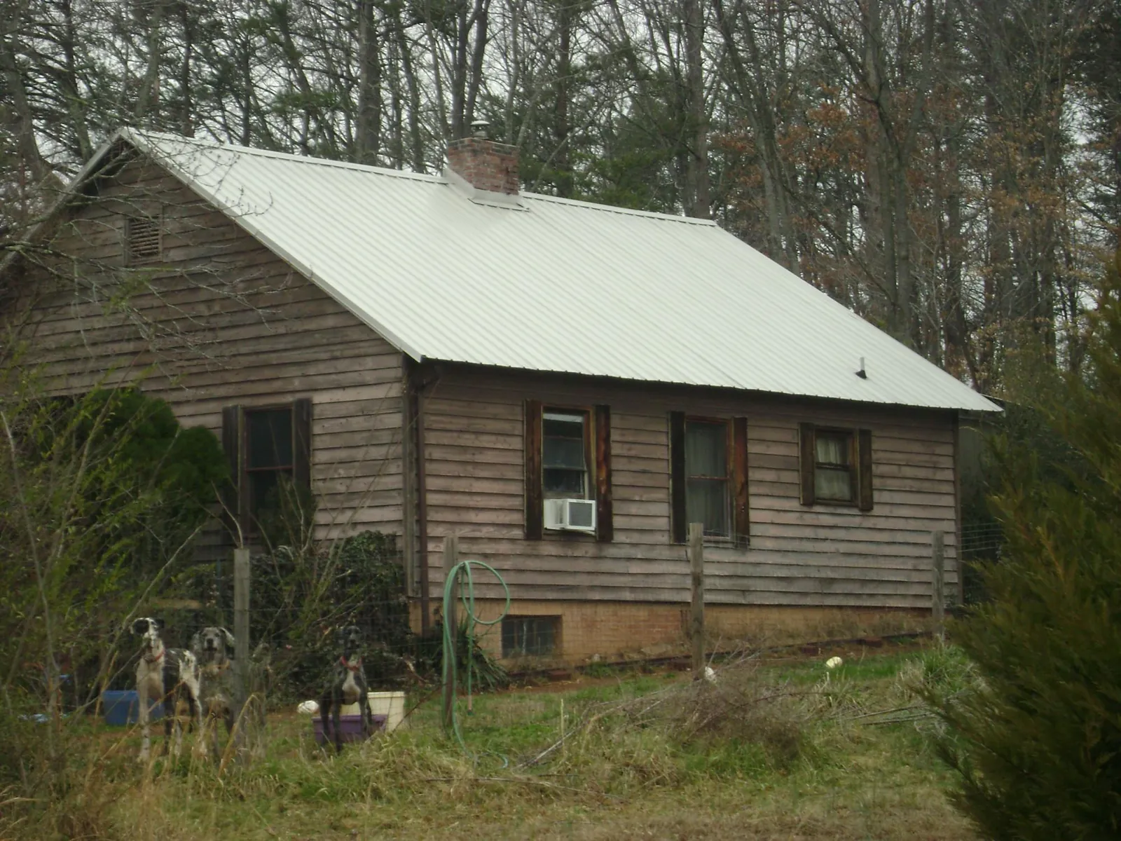 White metal roof on an old wood sided farmhouse, from a Metal Roof Installation job in Wood River Junction